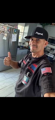 Pure Tek Air technician giving a thumbs up inside a customer's home