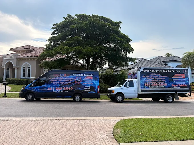 Pure Tek Air branded service van and box truck outside a residential property